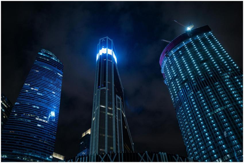 A breathtaking view of modern skyscrapers lit up a