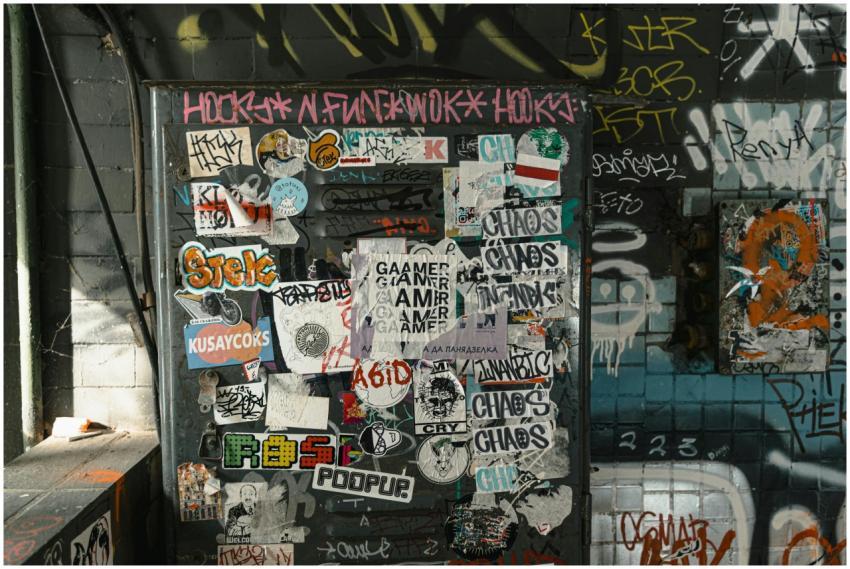 A vibrant wall covered with diverse stickers and g