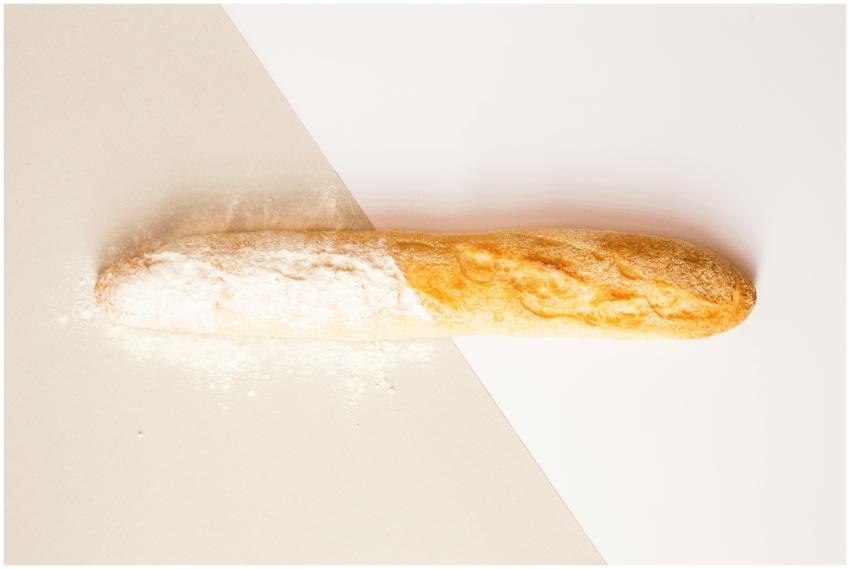Close-up of a fresh baguette dusted with flour on
