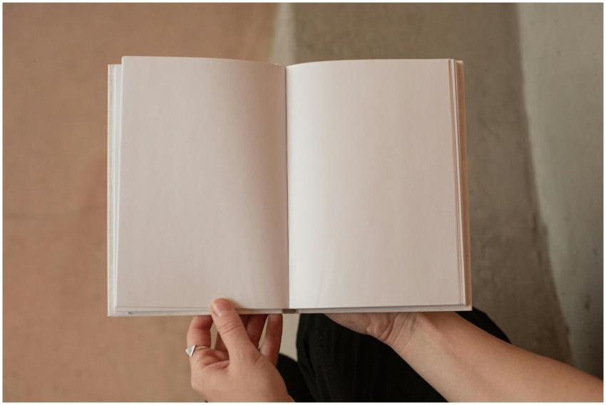 Hands holding an open blank notebook, perfect for