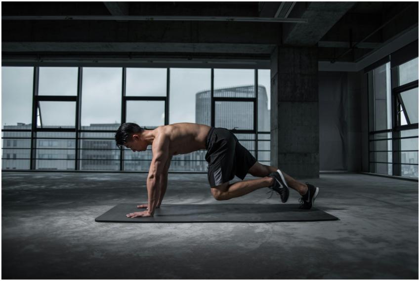 Fit man doing mountain climbers exercise inside a