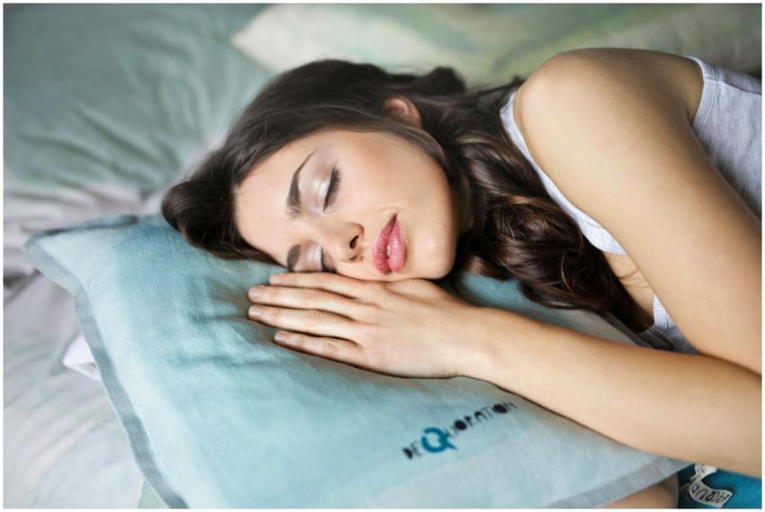 A woman peacefully sleeps on a soft pillow, captur
