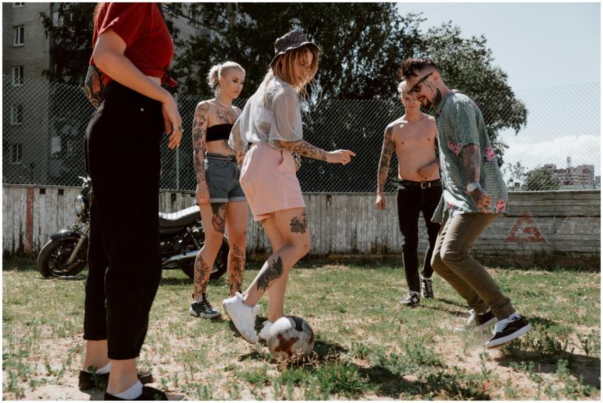 Group of tattooed friends enjoying a casual soccer