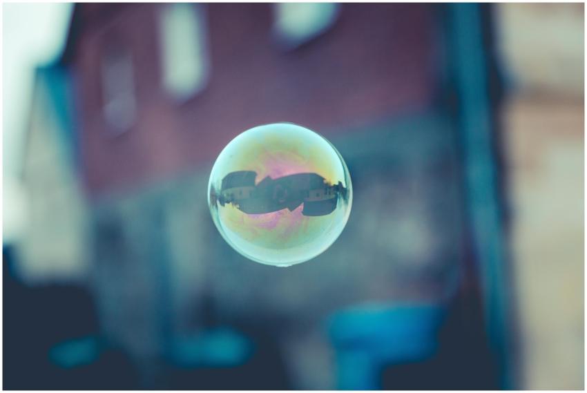 A single soap bubble reflecting buildings in an ur