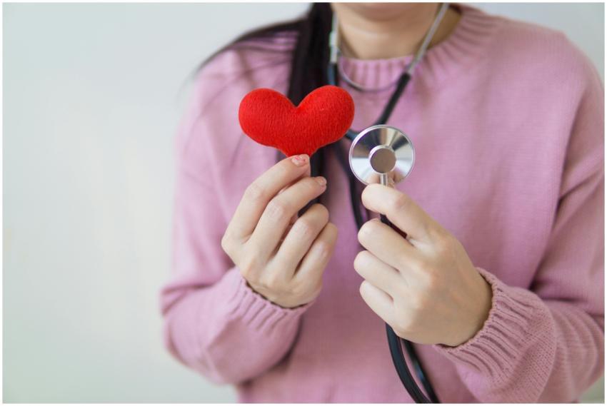 Unrecognizable female in pink sweater with stethos