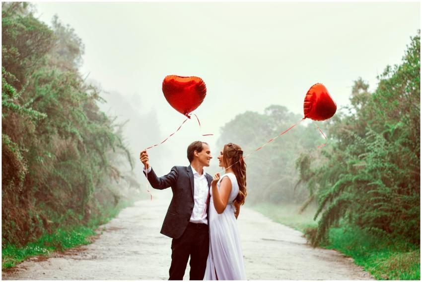 A loving couple embraces with heart-shaped balloon