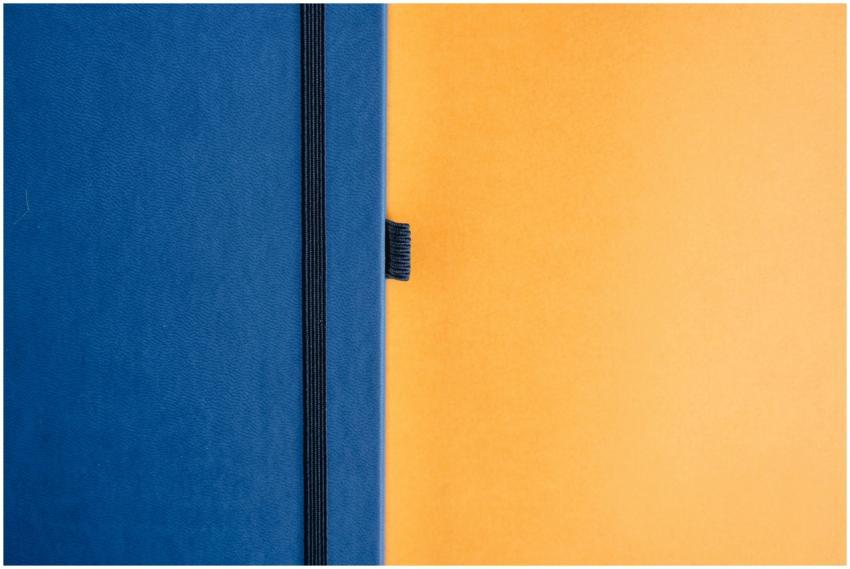 A minimalist design featuring a blue notebook agai