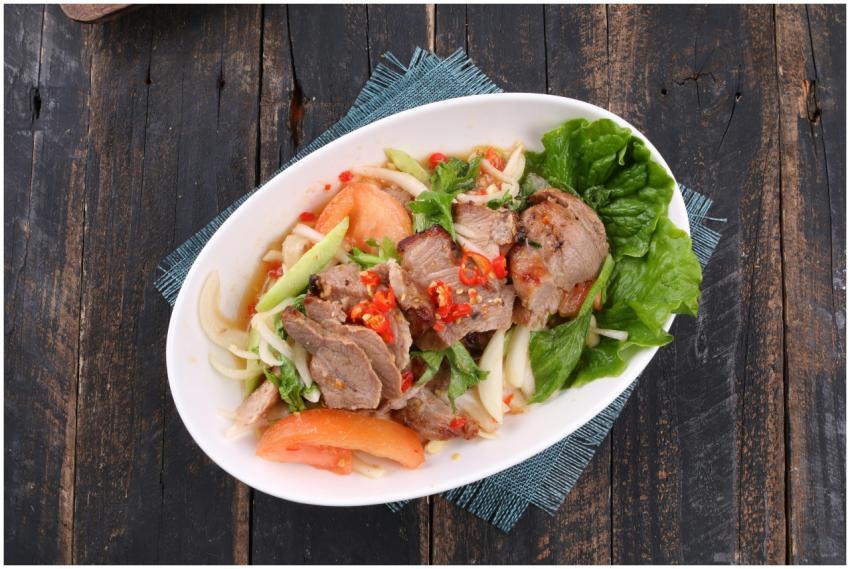 A fresh Asian salad with grilled meat, lettuce, an
