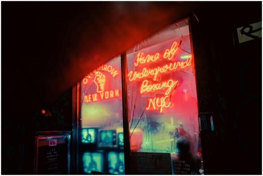 Exterior of shop with shiny neon inscriptions and