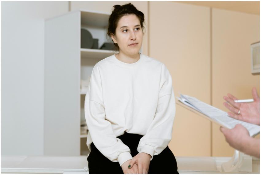 Adult woman sitting attentively during a medical c