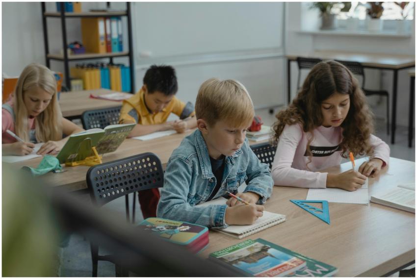 A group of children focused on studying in a class
