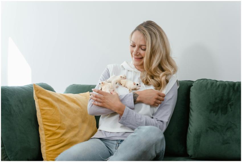 Happy woman sitting on a sofa, smiling and holding