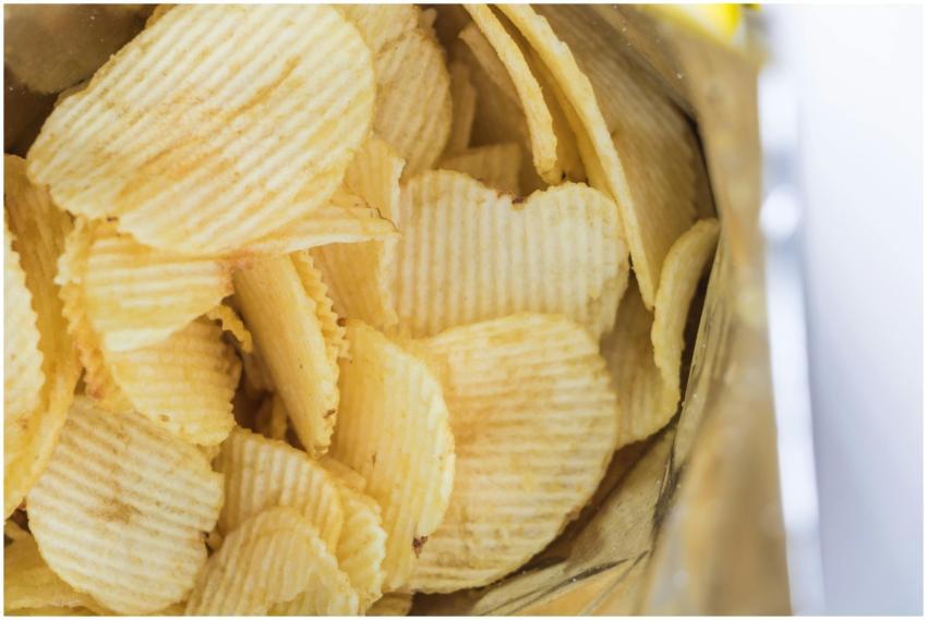 Close-up of ridged potato chips inside an opened s