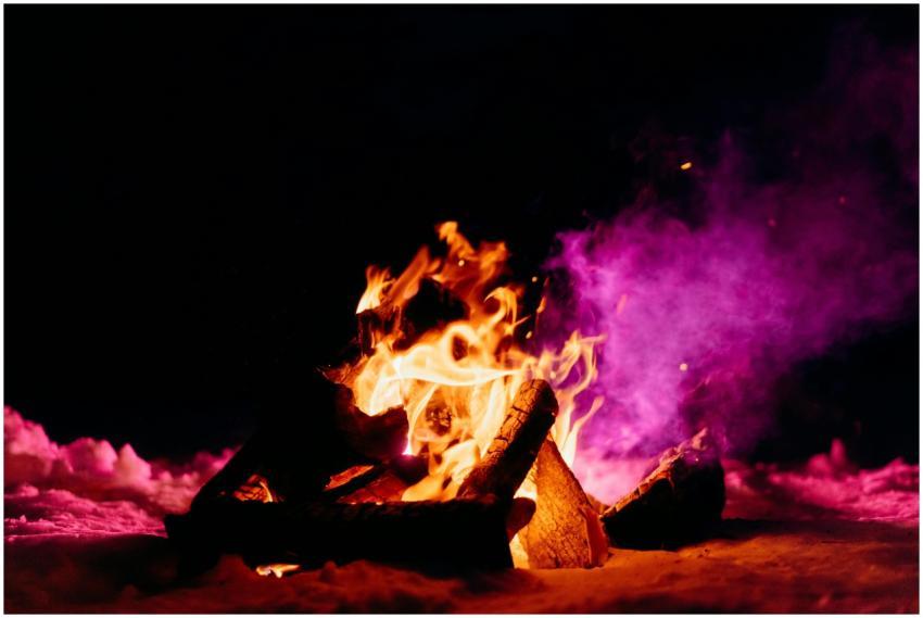 A lively winter bonfire illuminating the snow and