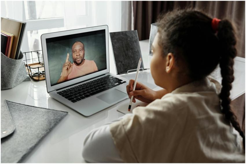 A child engaged in online learning with a teacher