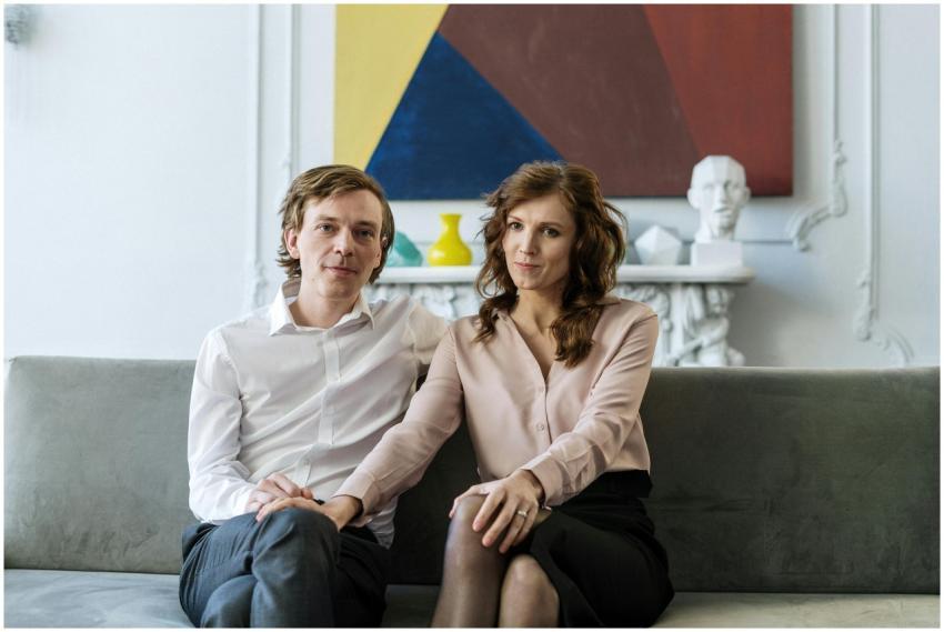 A couple sitting on a couch during a counseling se