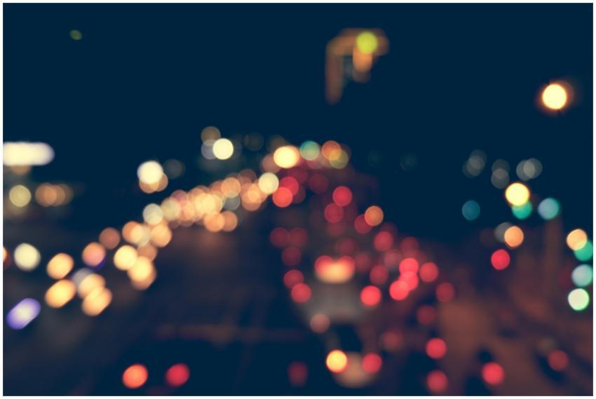 Blurred city traffic at night with colorful bokeh
