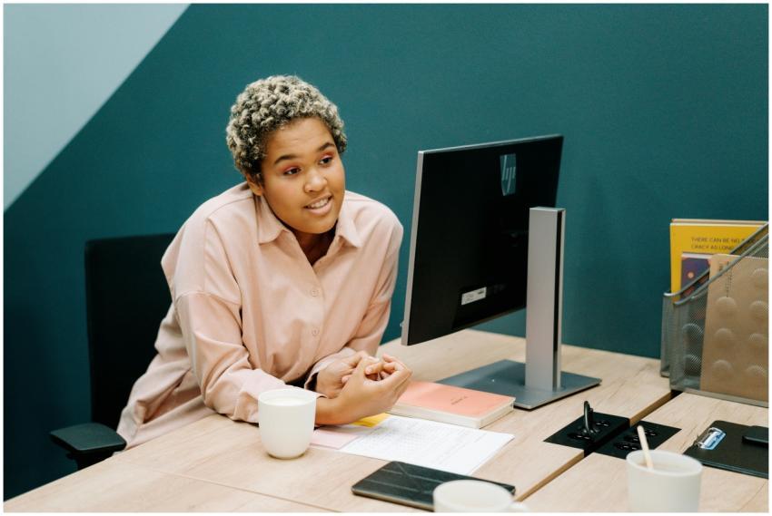 Professional woman in office, discussing work at h