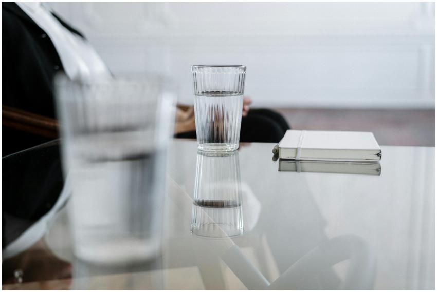 A minimalist composition featuring a glass of wate