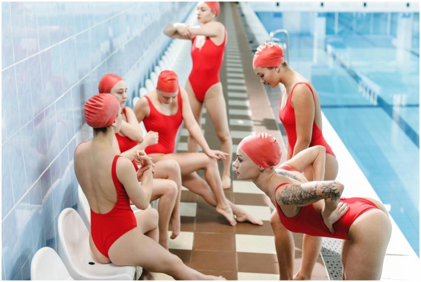 Group of women warming up by the indoor swimming p