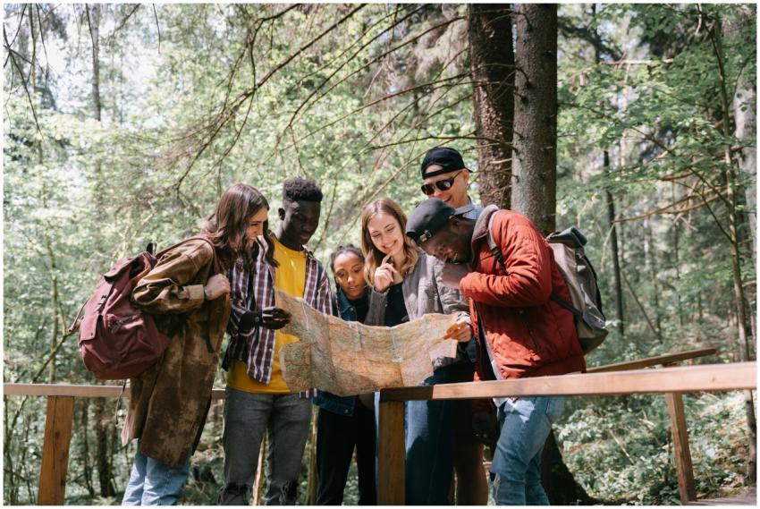 Group of diverse friends navigating a forest trail