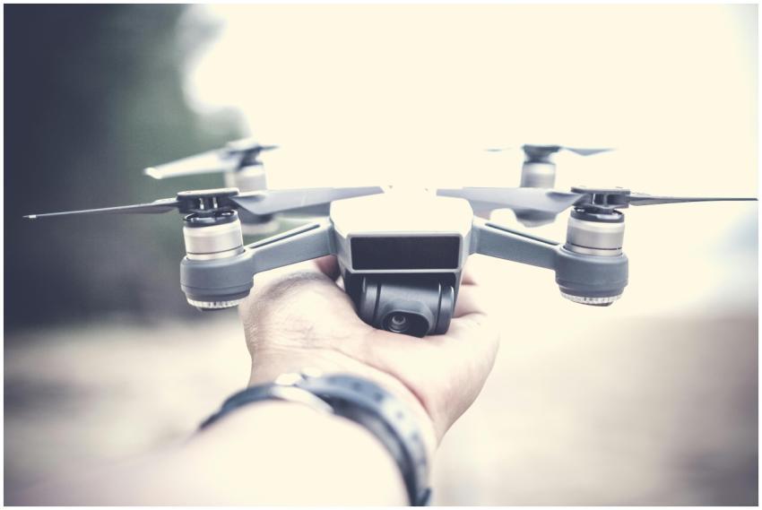 A close-up shot of a person holding a modern drone