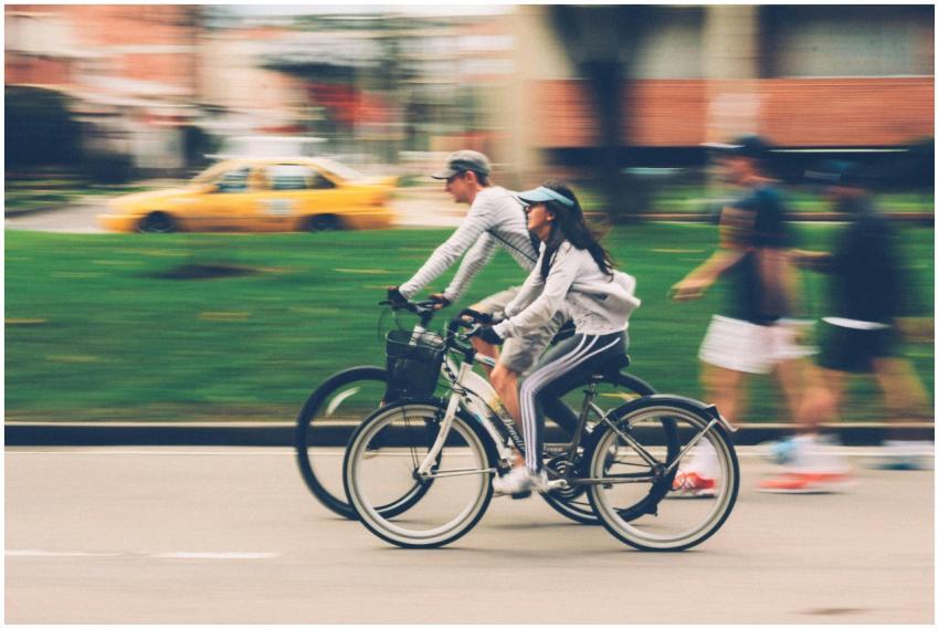 Blurred image of a couple cycling in a city street