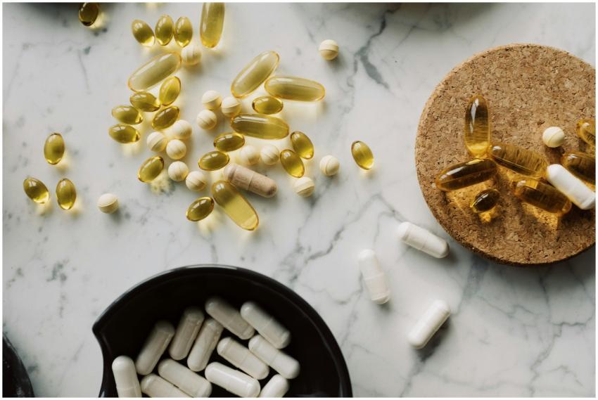 From above of mixed white vitamins and omega place