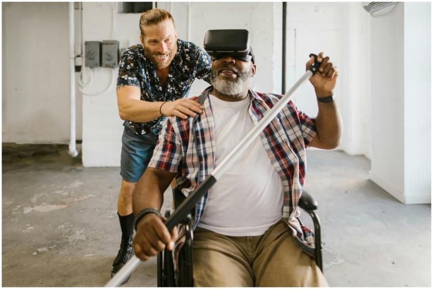 Man assists wheelchair user engaged in rehabilitat