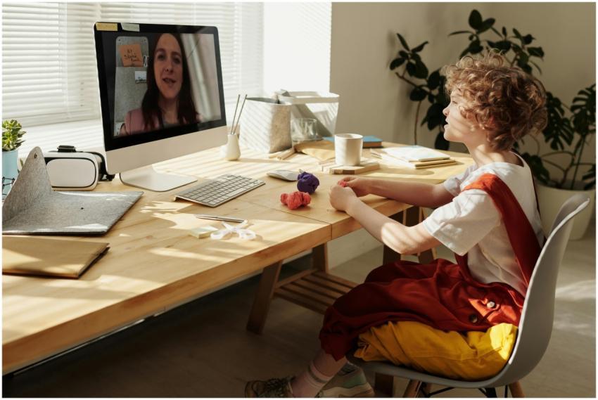 Young child using computer for distance learning w