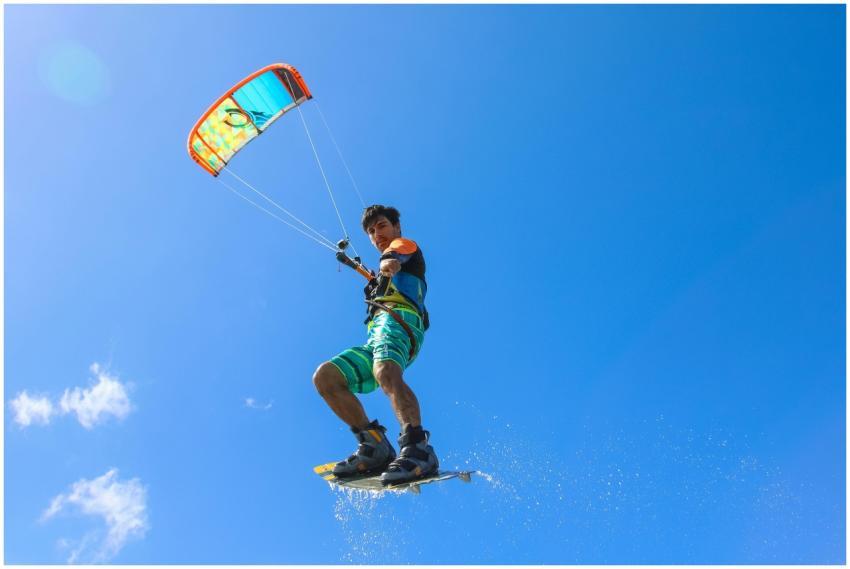 A thrilling kiteboarder performing stunts in the a