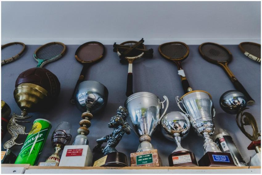 A collection of vintage sports equipment and troph