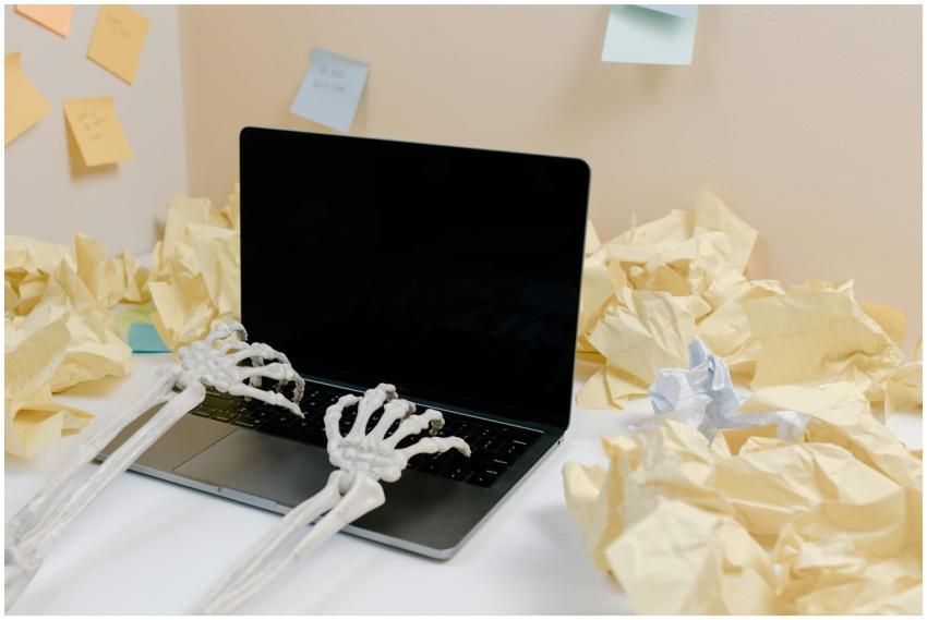 A humorous scene with skeleton hands typing on a l