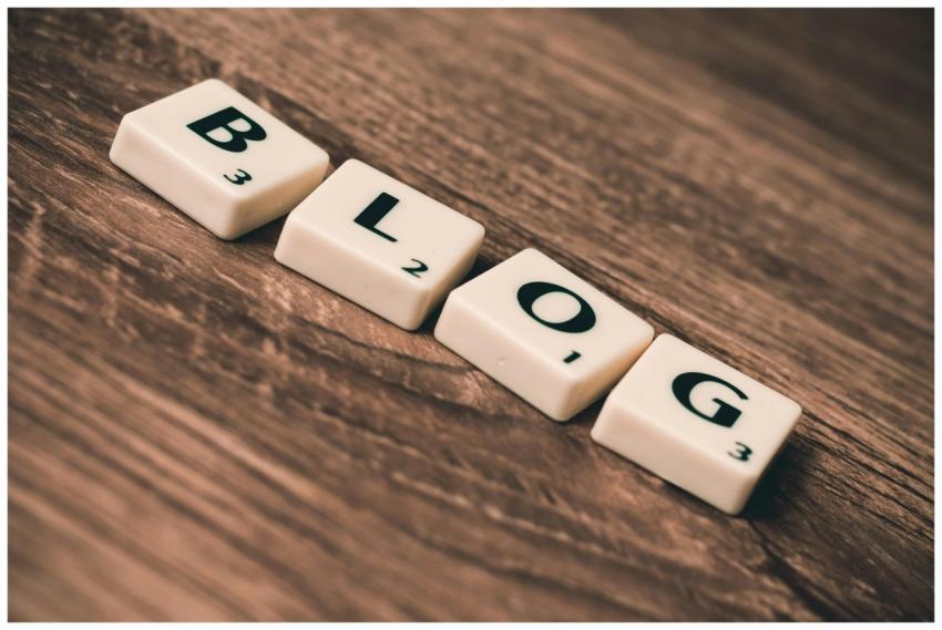 Scrabble tiles spelling 'BLOG' on a wooden backgro