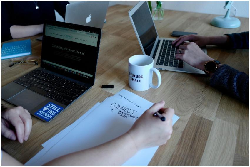 Team working with laptops and notes during a meeti