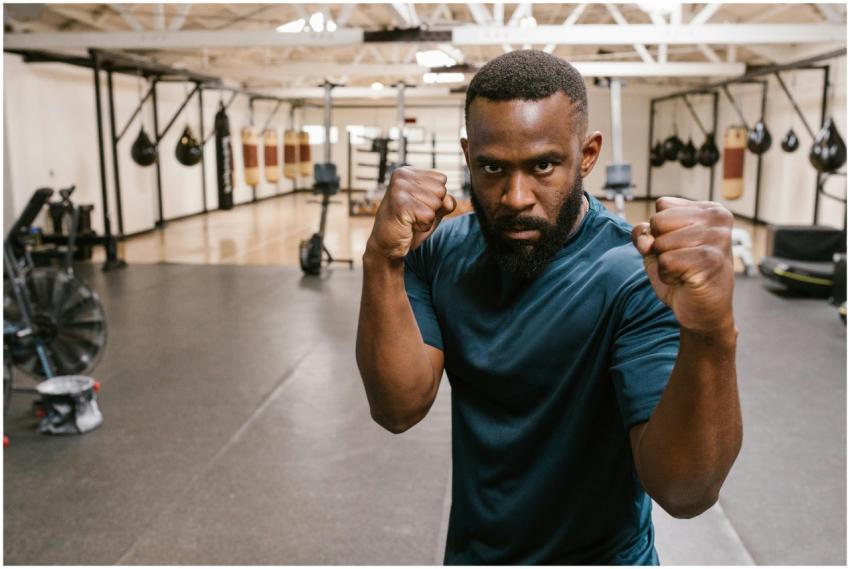Focused boxer in an indoor gym practicing fighting