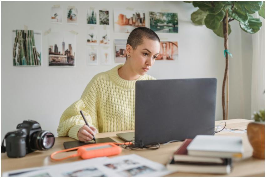 Thoughtful female in casual sweater working on net
