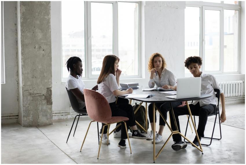 Full length concentrated multiethnic coworkers in