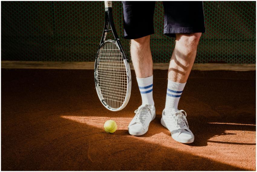 Close-up of a tennis player with racket and ball o