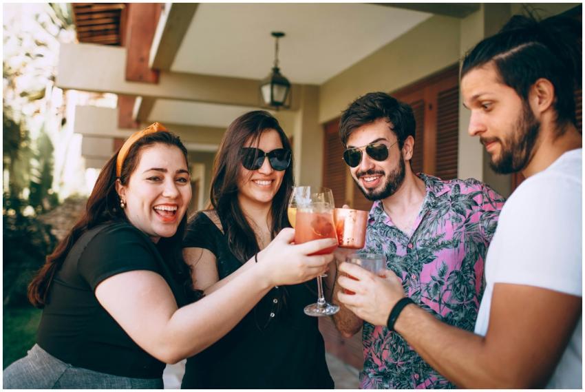 Happy group of friends enjoying a toast with drink