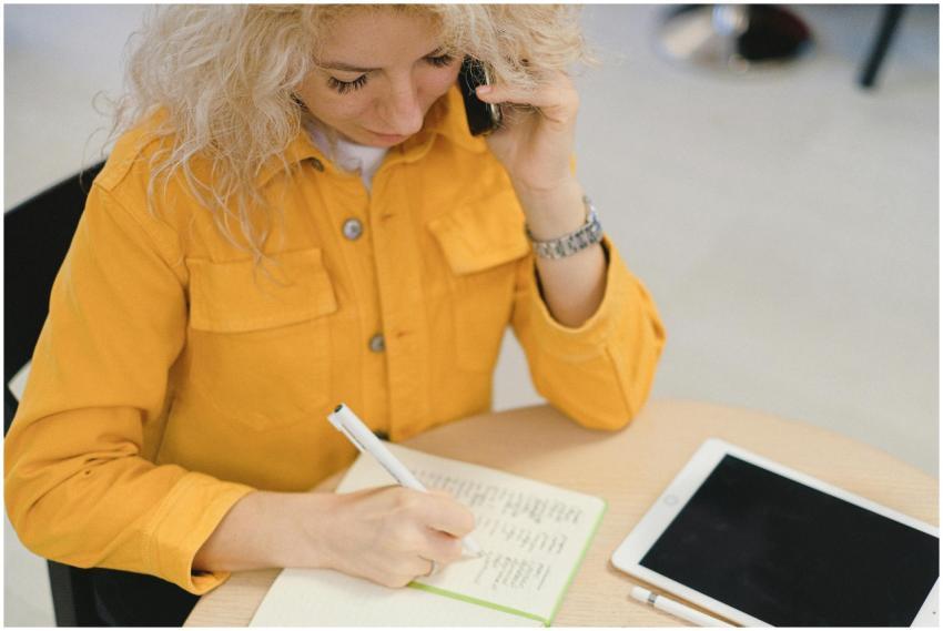 From above of female freelancer taking notes in no