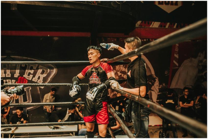 A boxer receives coaching during an intense match