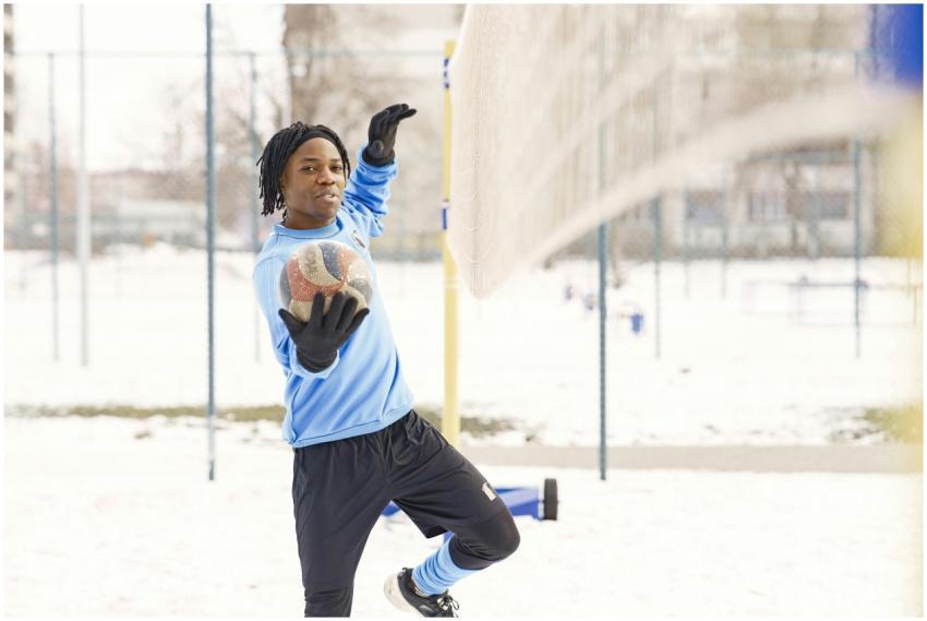 Athlete playing volleyball outdoors in winter weat