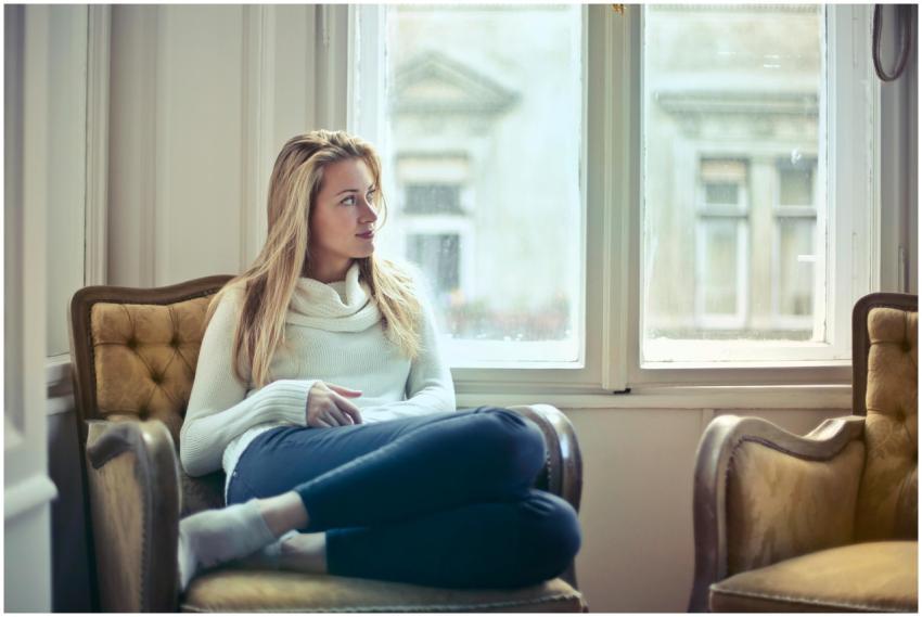 A serene moment of a woman in a cozy room, enjoyin