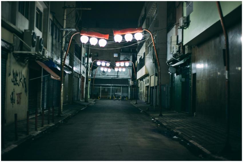 A deserted urban alley at night featuring unique r