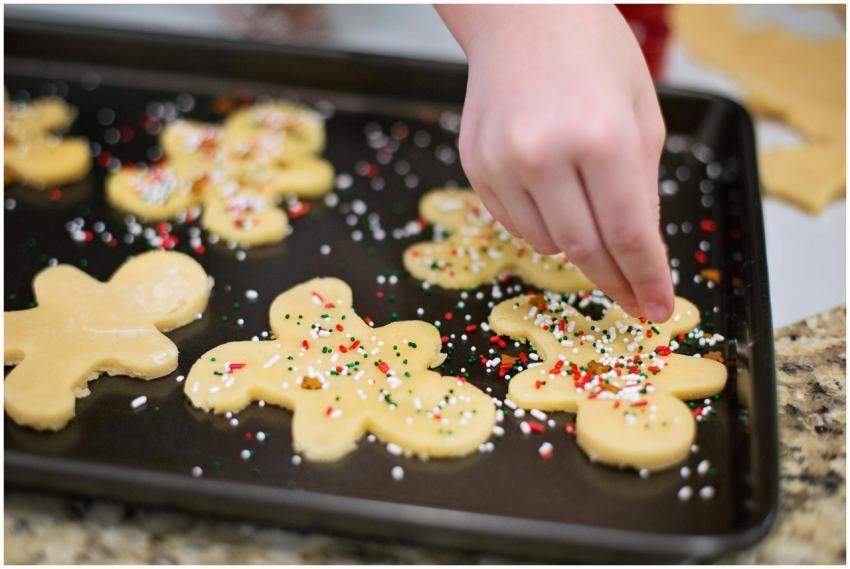 A close-up of gingerbread cookies being decorated