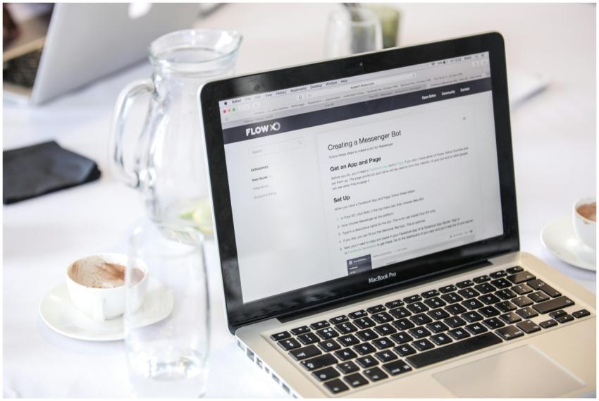 Close-up of a MacBook Pro displaying a webpage, wi