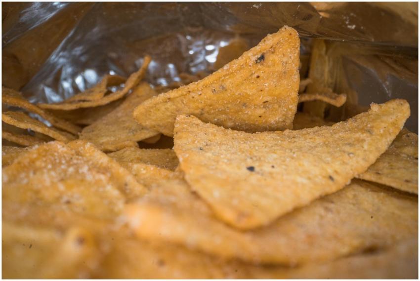 Macro shot of salted tortilla chips inside an open
