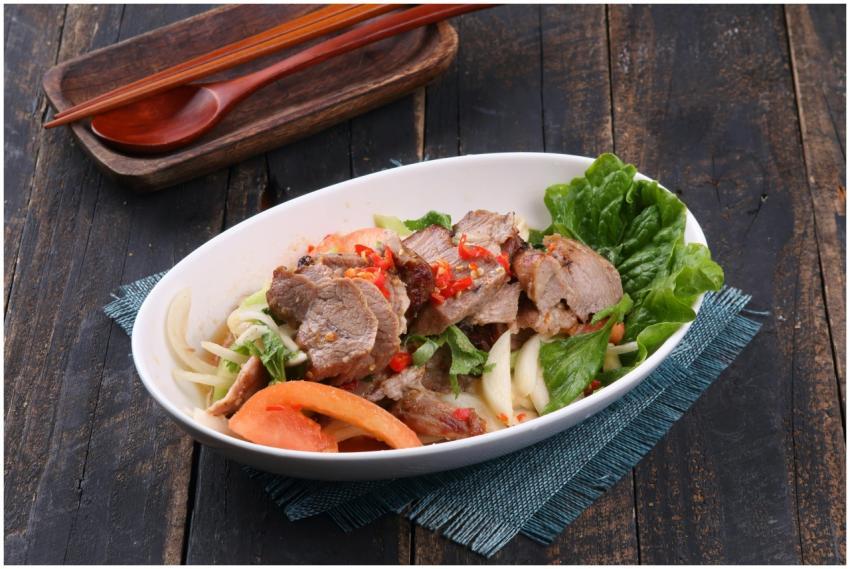 A vibrant Asian-style meat salad with fresh vegeta