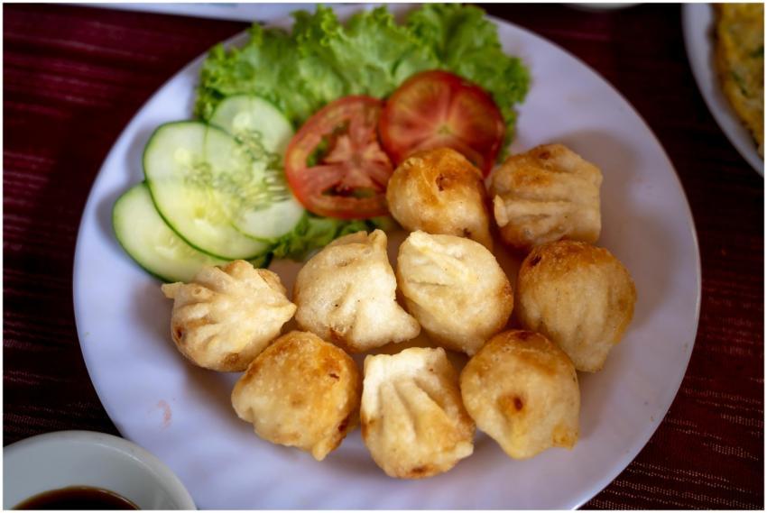Close-up of fried dumplings served with fresh cucu